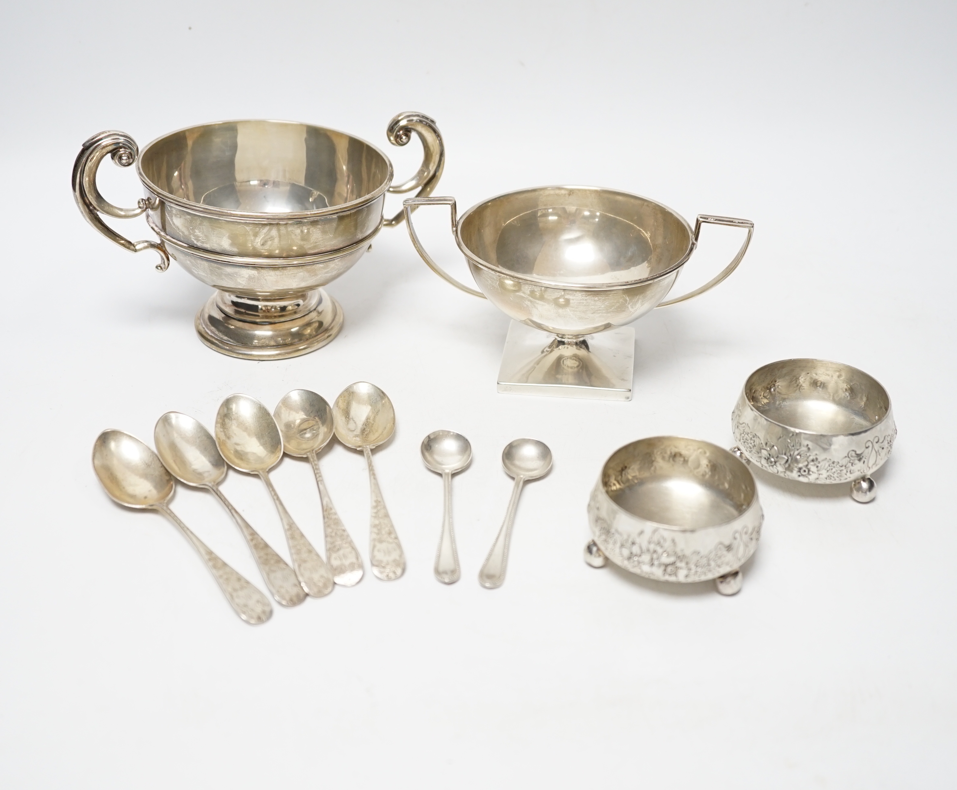 An Edwardian silver two handled bowl, Chester, 1902, diameter 10.4cm, a sterling bowl, a pair of engraved silver tub salts and matching salt spoons, Mappin & Webb, Sheffield, 1908 and a set of five silver teaspoons.